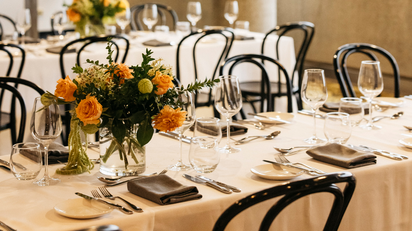 A dining place setting across 2 tables.