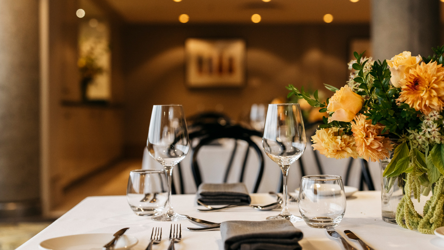 A dining place setting with a bouquet of flowers.