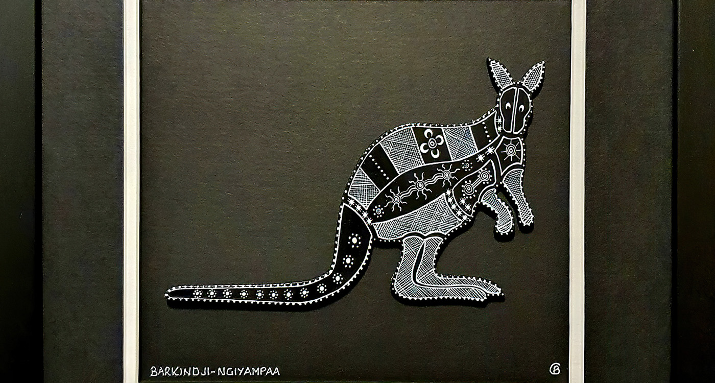 An intricately painted black and white, wooden kangaroo