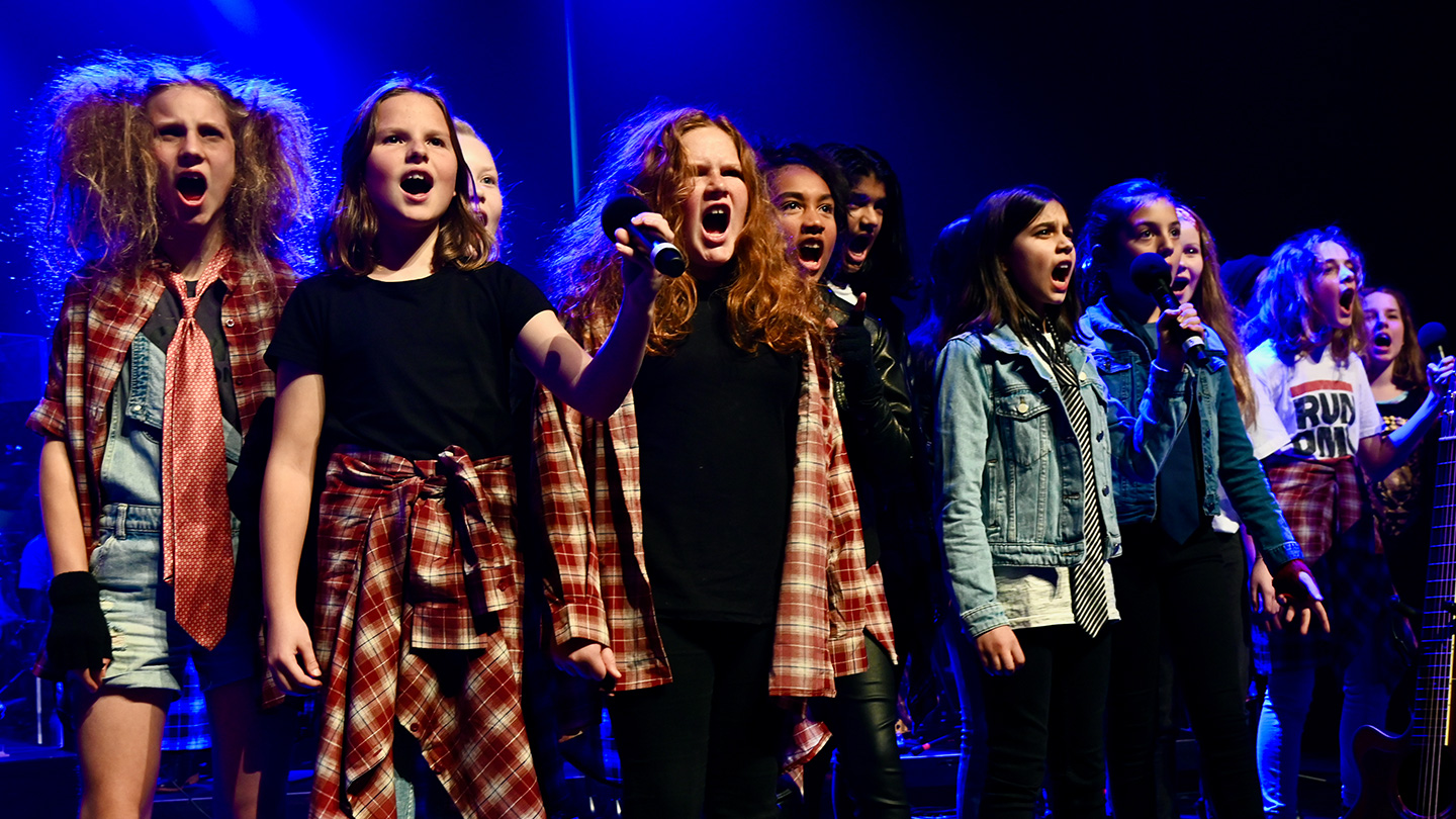 A choir of children singing on stage
